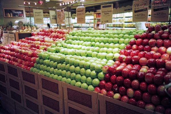 red and green apples on brown wooden crateby Scott Evans