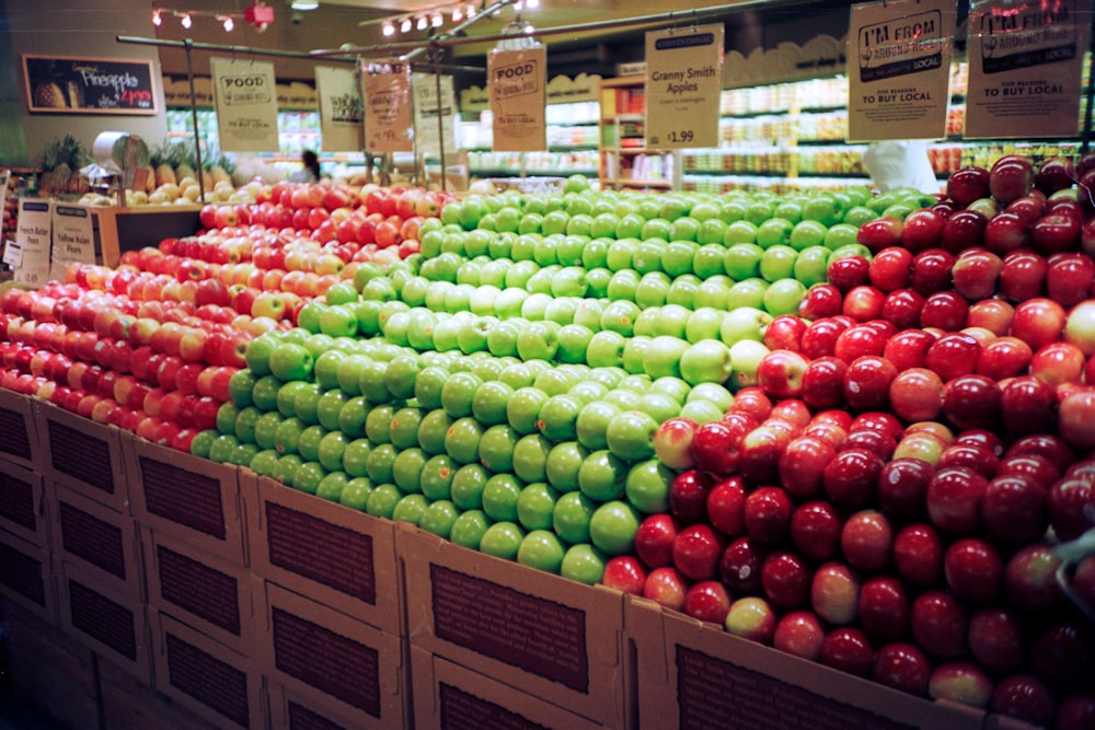 red and green apples on brown wooden crate
