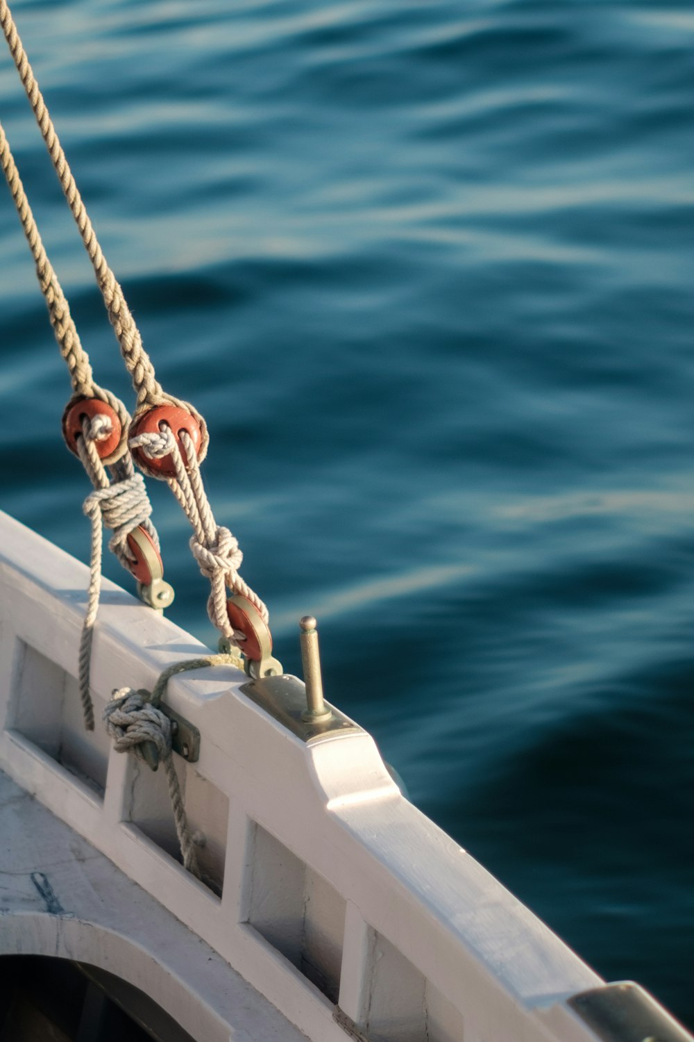 white and brown boat with rope