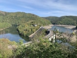 A panoramic view of a hydroelectric dam in Nigeria surrounded by lush greenery.