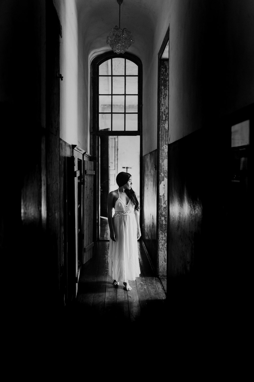 woman in white dress walking on hallway