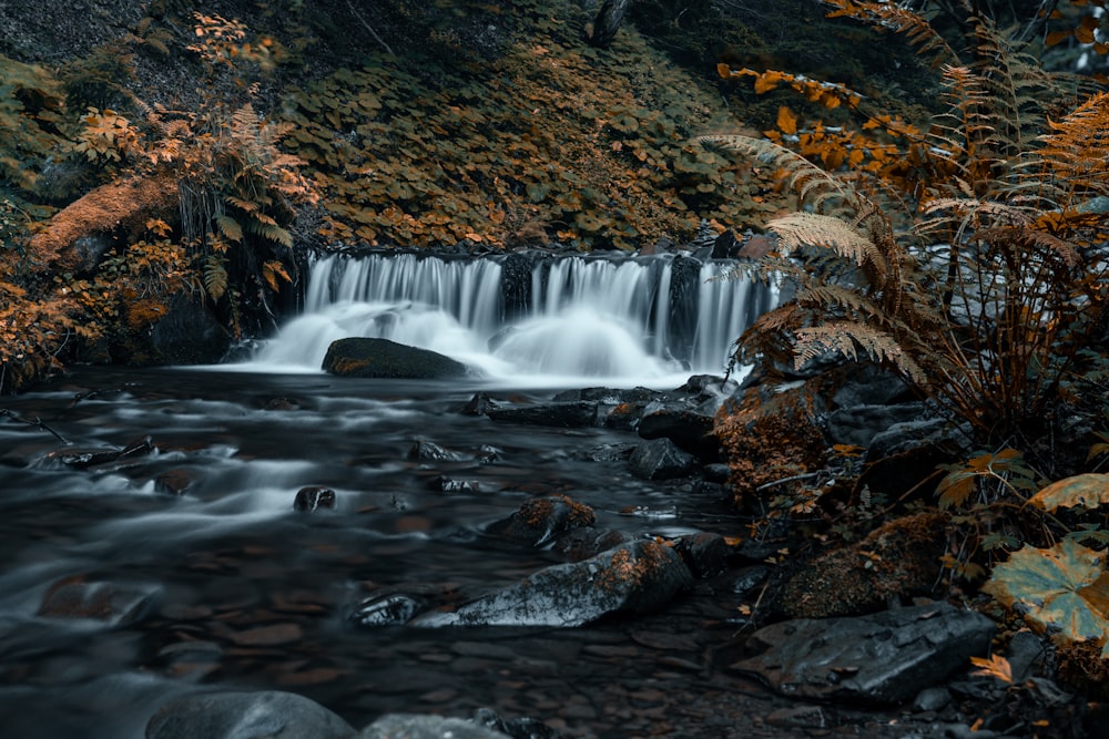 water falls on brown rocky mountain