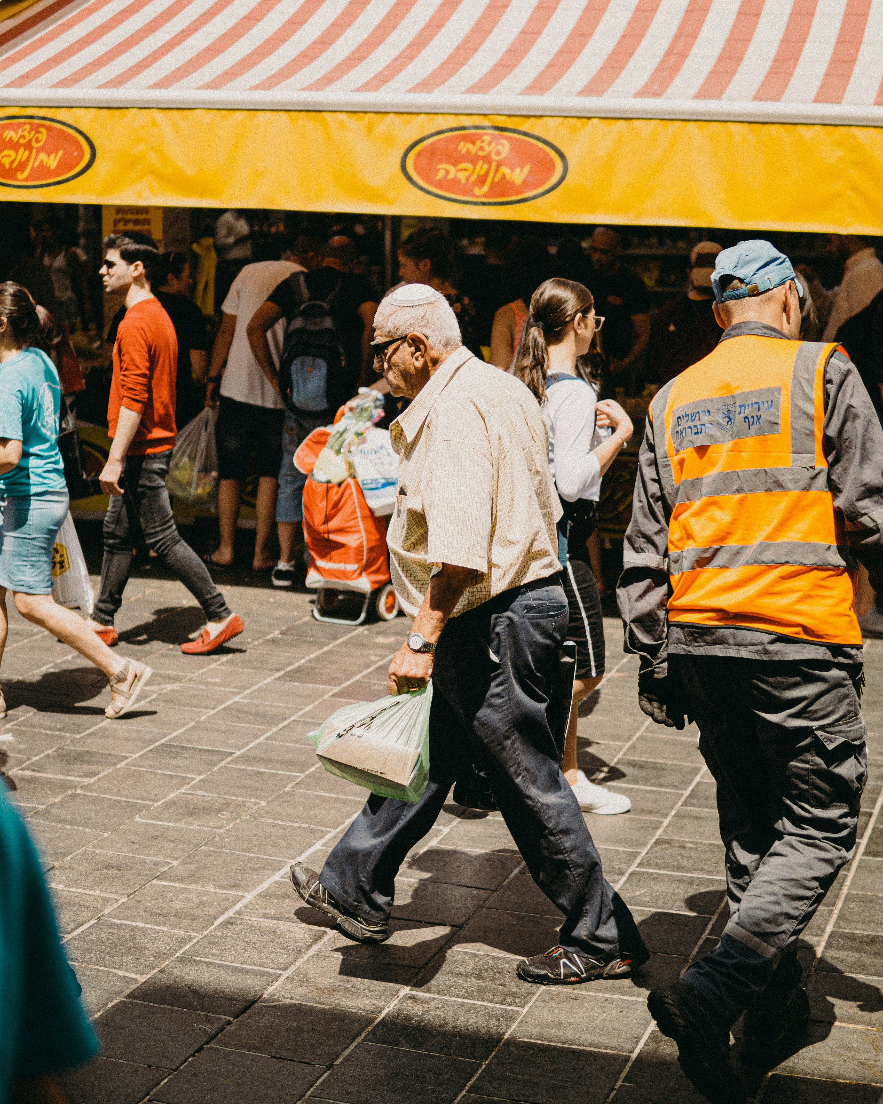 man in white dress shirt and black pants walking on sidewalk during daytime
