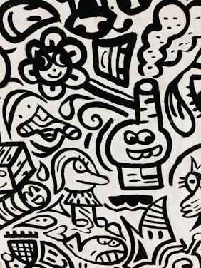 A black and white abstract pattern features cartoon-like characters and playful shapes. Among these are a smiling flower, a fish, a whimsical face with a hat, and a box with facial features. Curved lines and swirls interweave to create a dynamic composition.