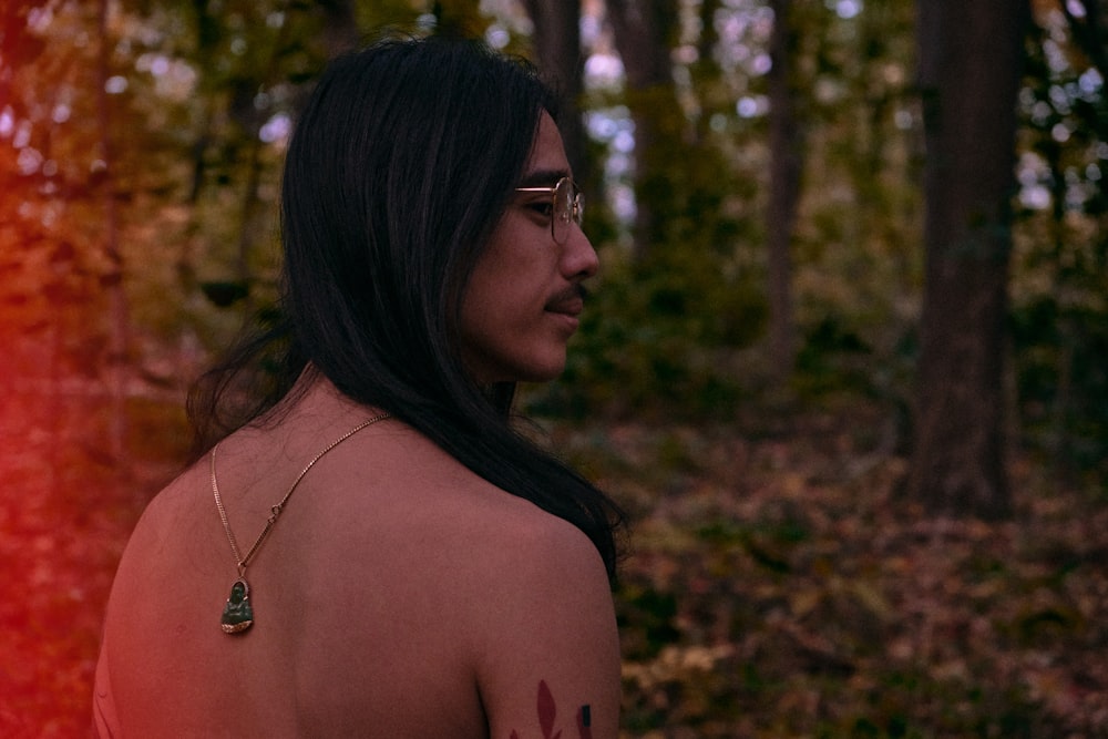 topless woman wearing silver necklace