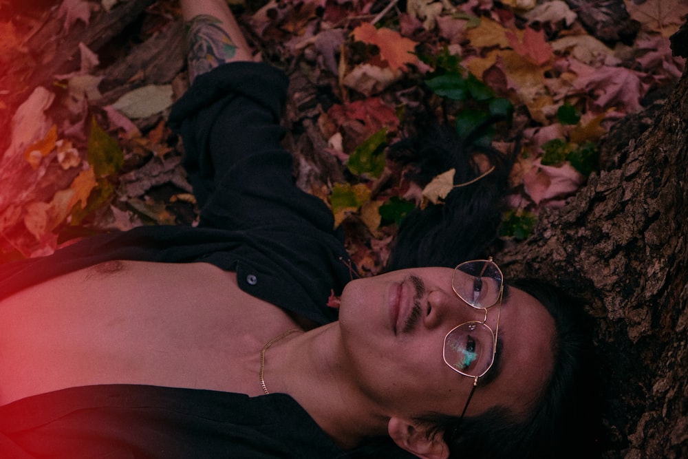 man in black jacket lying on ground