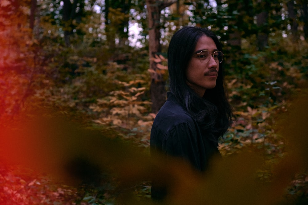 woman in black jacket wearing black framed eyeglasses