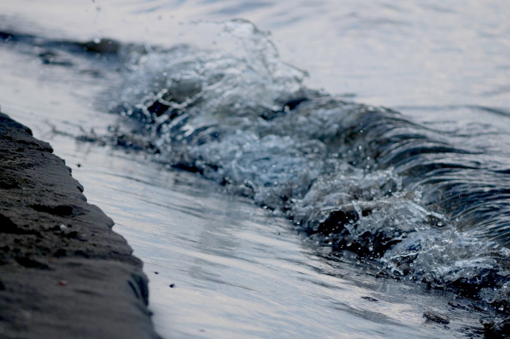 water waves on gray rock