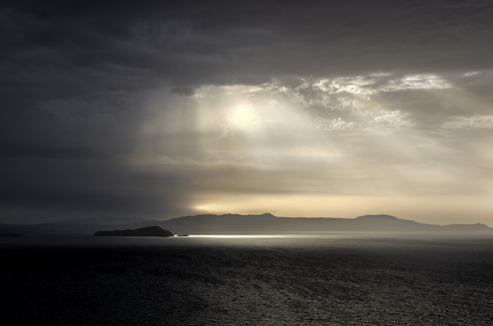 body of water under cloudy sky during daytime