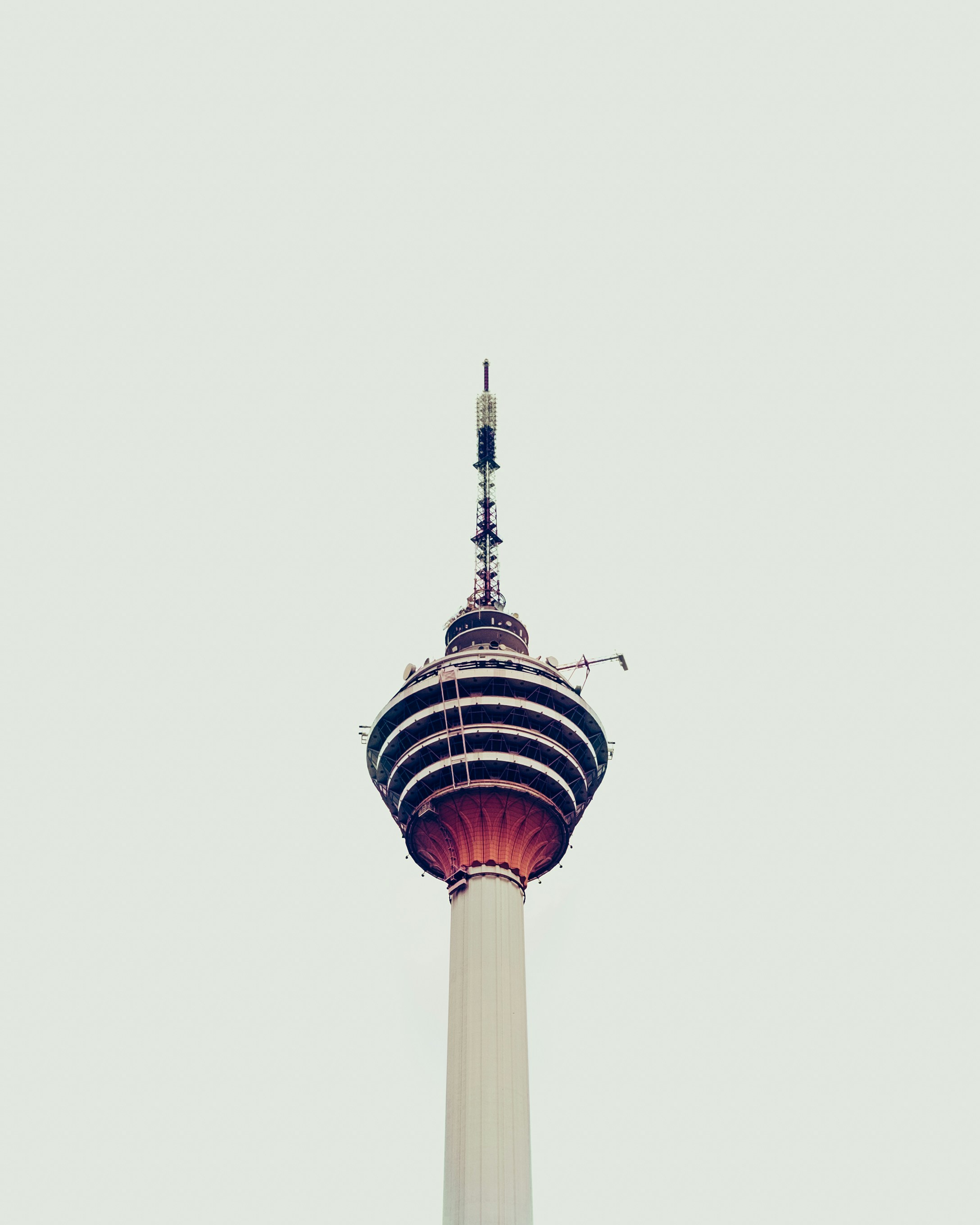 white and red tower under white sky