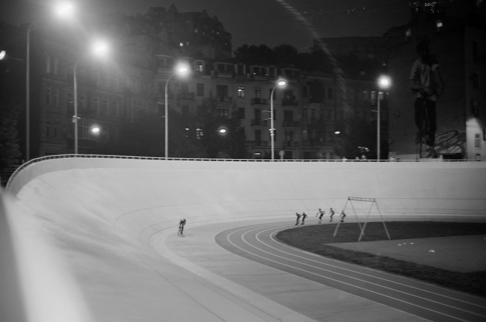 grayscale photo of people walking on snow covered road