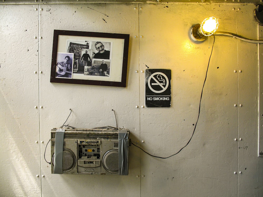 gray and black radio on white wall