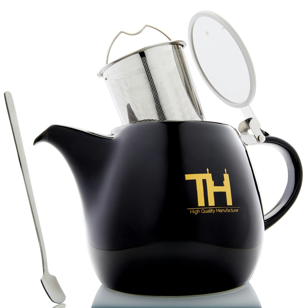 black and yellow ceramic teapot