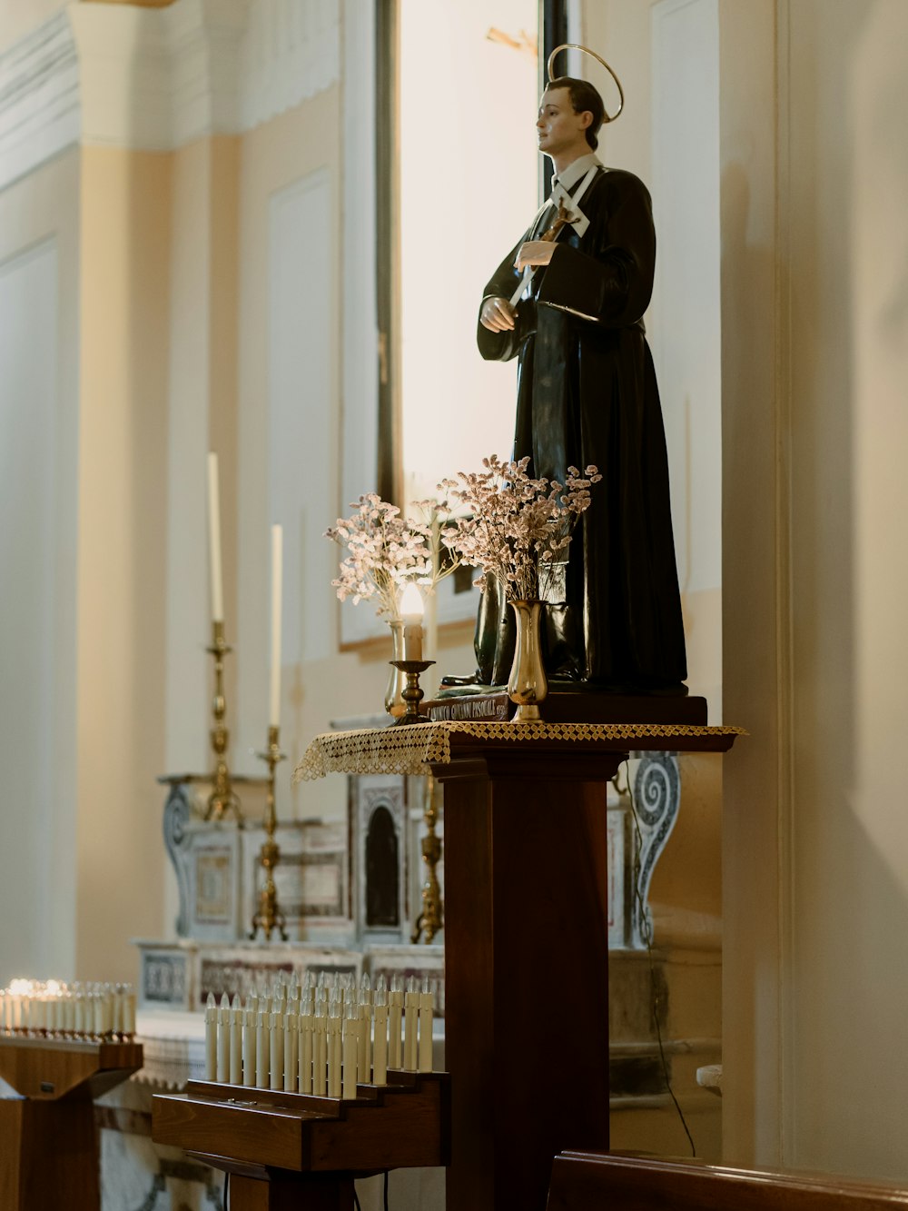 gold and black statue on brown wooden table