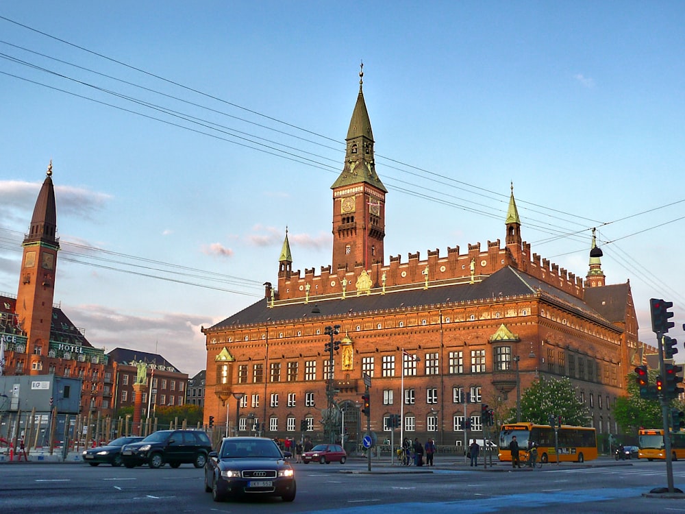 cars parked in front of brown building during daytime