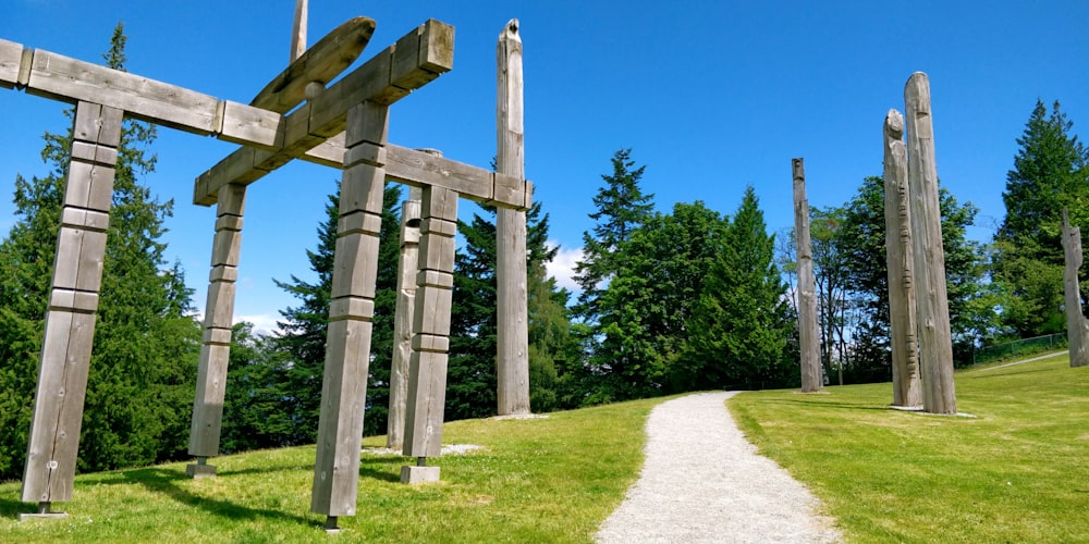 brown wooden cross on green grass field during daytime