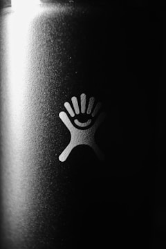 Close-up of a bold black and white logo design on textured paper.