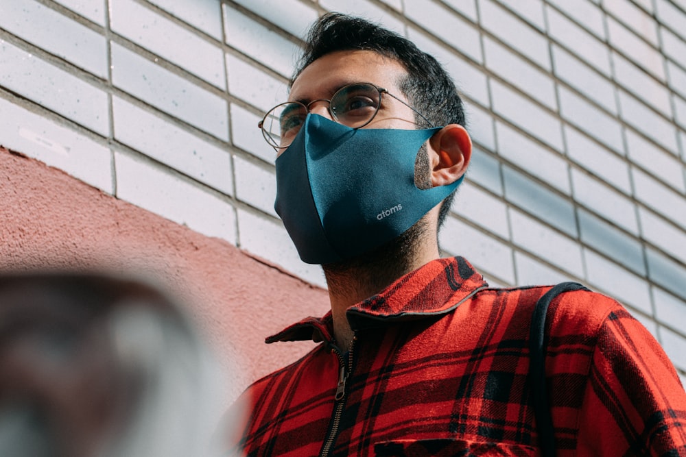 boy in red and black checkered button up shirt wearing blue mask