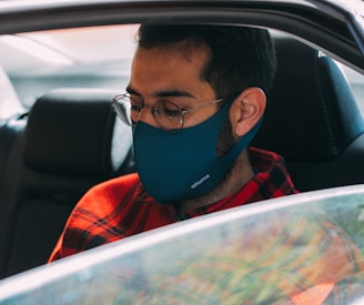 boy in red and black jacket wearing blue mask