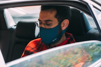 boy in red and black jacket wearing blue mask