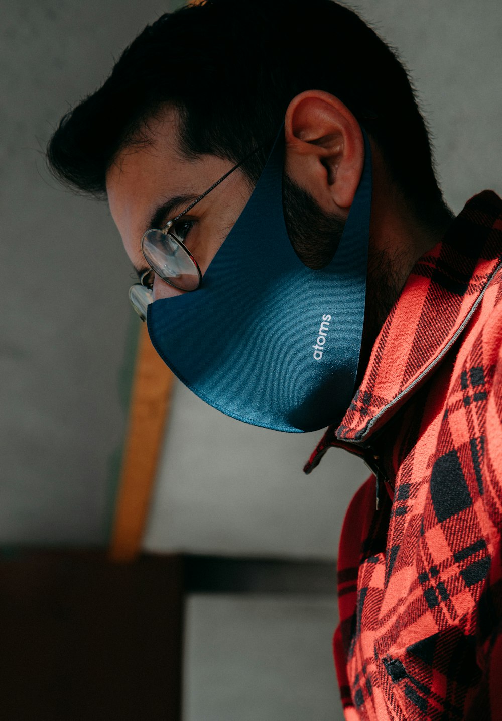 man in red and white plaid shirt wearing blue and white goggles