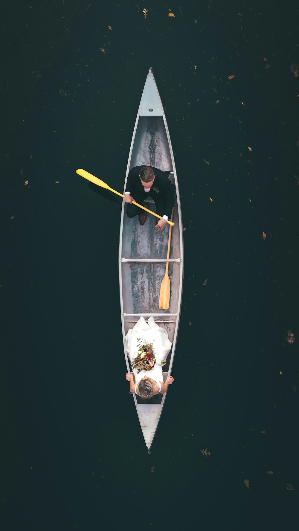 man in black shirt riding on brown boat