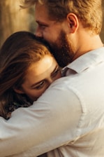 A cozy scene showing two people sharing a comforting hug, surrounded by soft light.