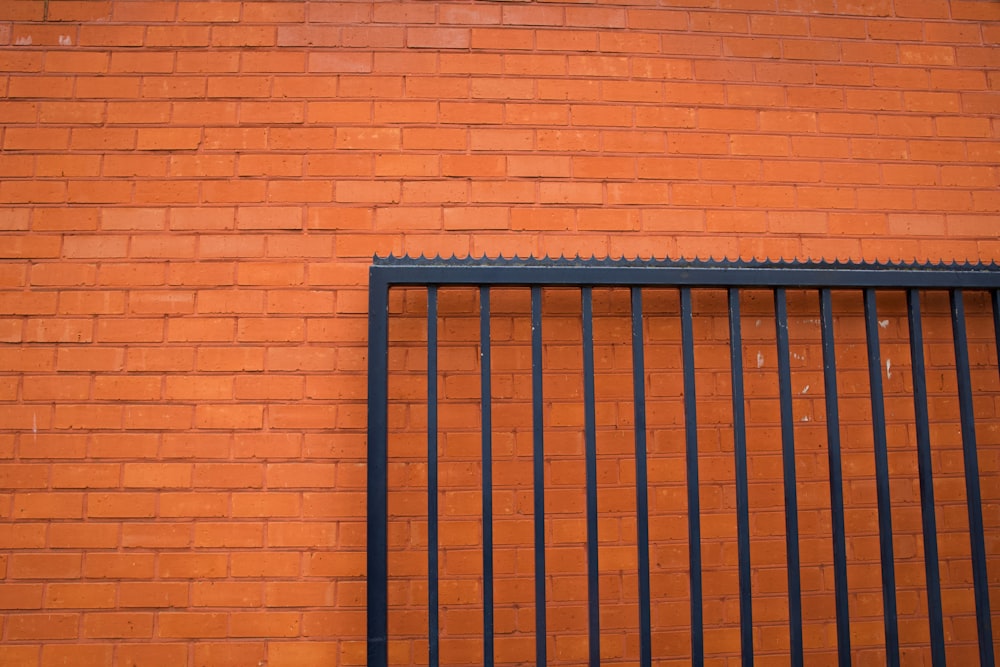 blue metal gate on brown brick wall