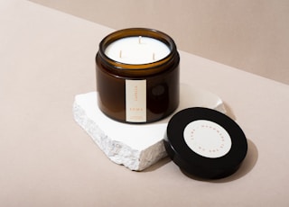 black round container on white tissue paper