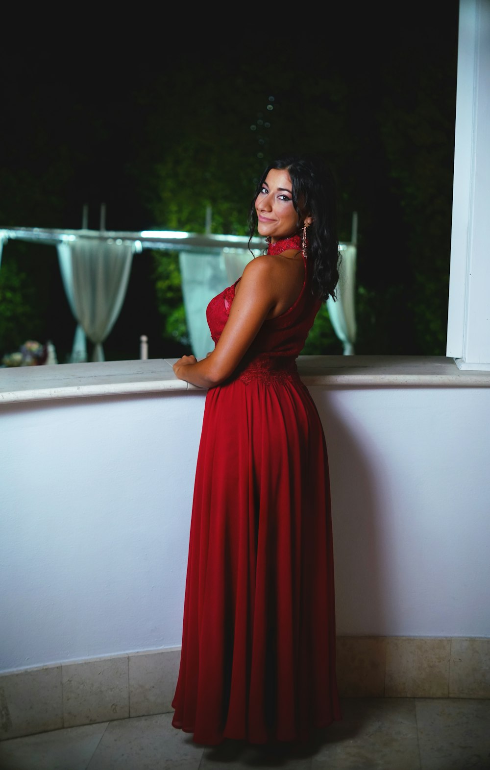 woman in red dress standing beside bathtub