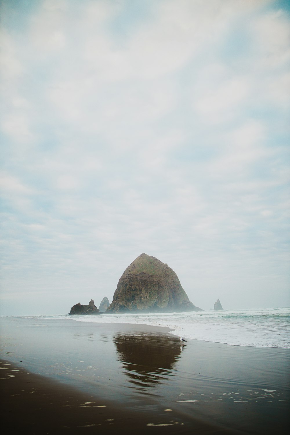 brown rock formation on sea during daytime