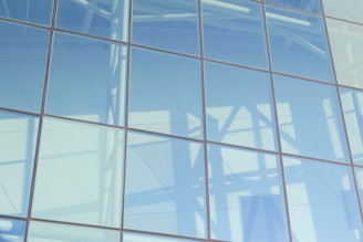 Close-up of sleek aluminium facade panels reflecting soft daylight.