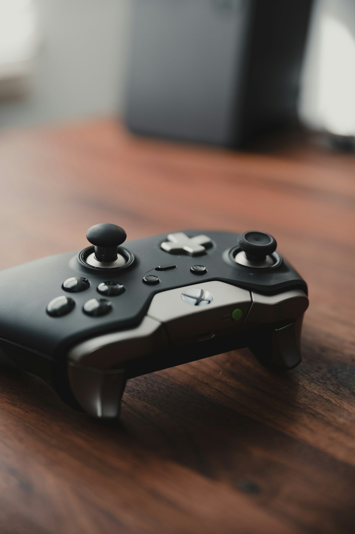 A video game controller on a wooden table representing the gaming industry facing AI disruption