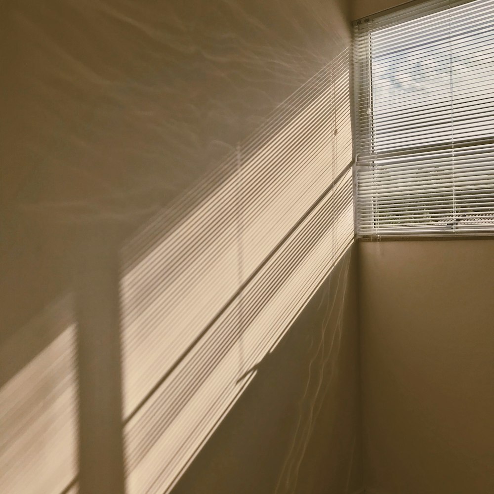 white window blinds on white wall