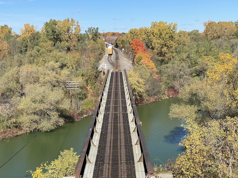 train rail near river during daytime