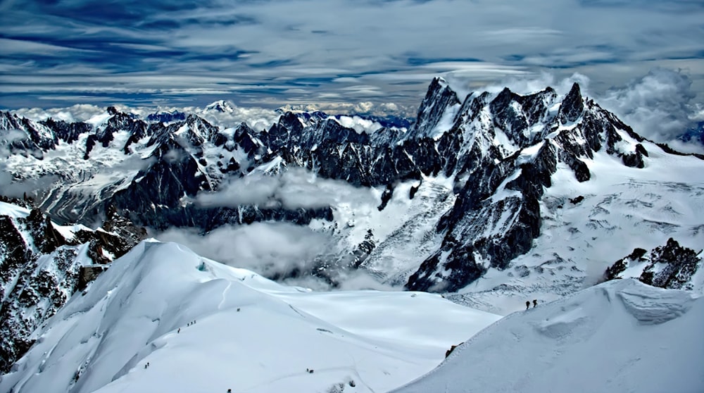 snow covered mountain under cloudy sky during daytime