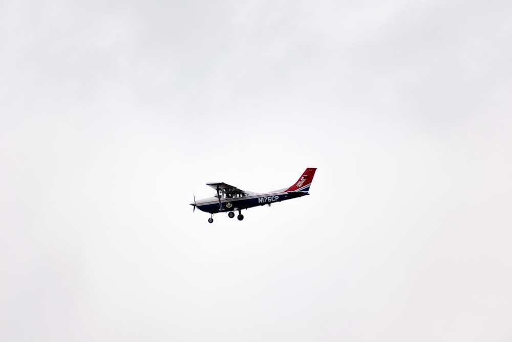 white and red airplane in mid air