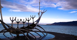 black metal bench on gray concrete dock during daytime