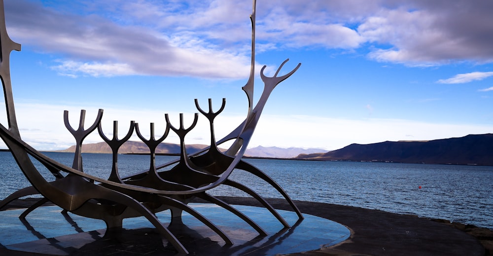 black metal bench on gray concrete dock during daytime