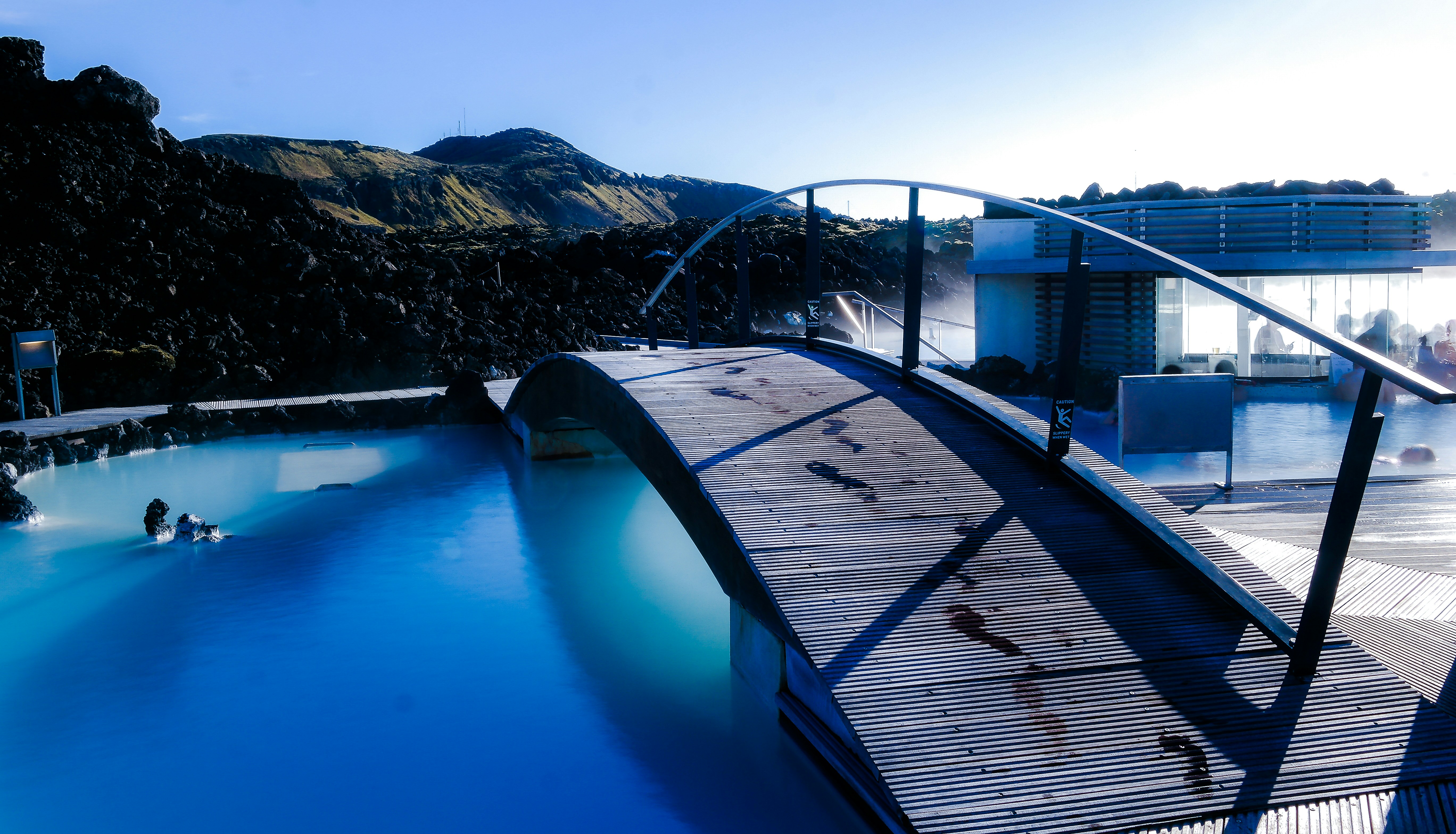 blue and black swimming pool near brown wooden dock during daytime, Blue Lagoon.