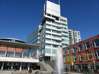 water fountain in front of white concrete building during daytime