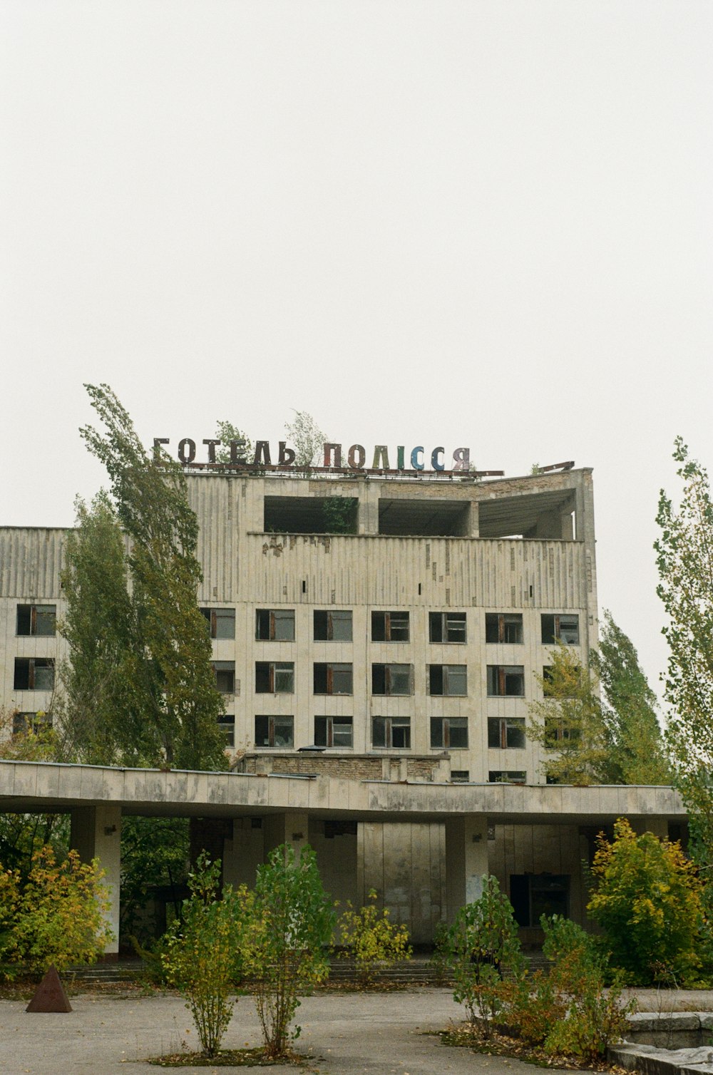 white concrete building near green trees during daytime