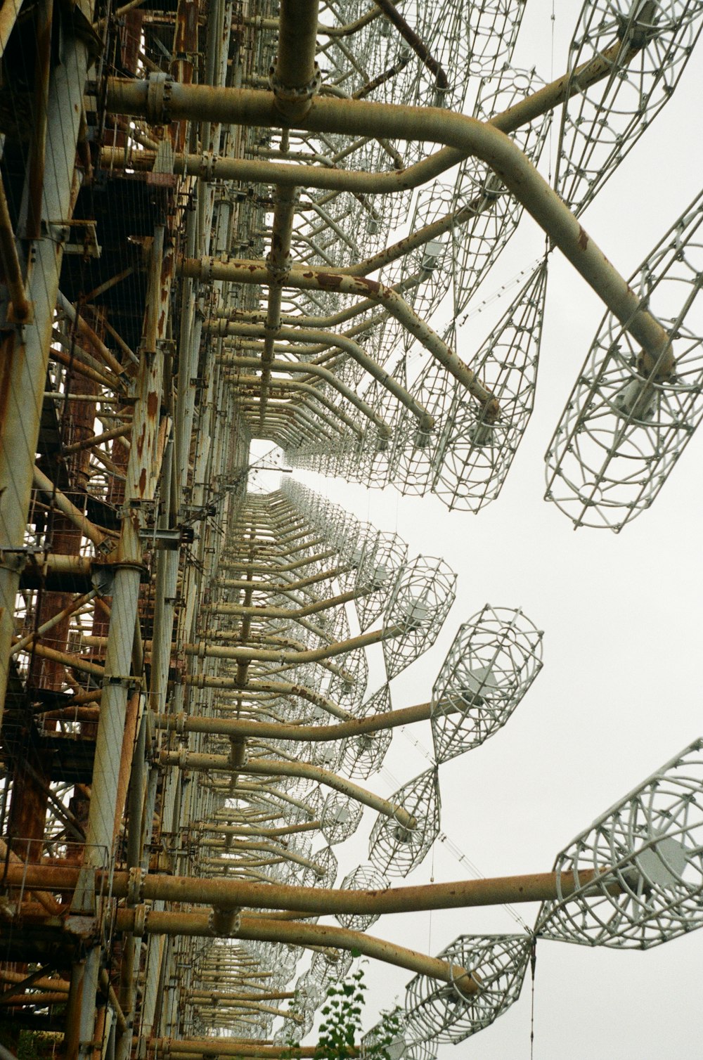 brown metal tower under white clouds during daytime