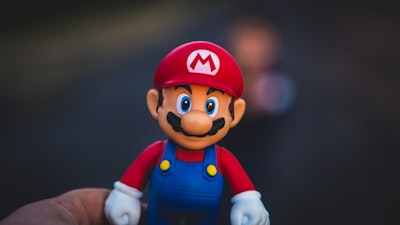super mario in blue and red shirt figurine super teams background