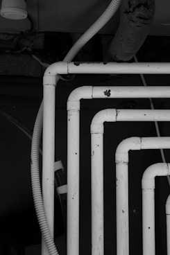 white metal pipe in grayscale photography
