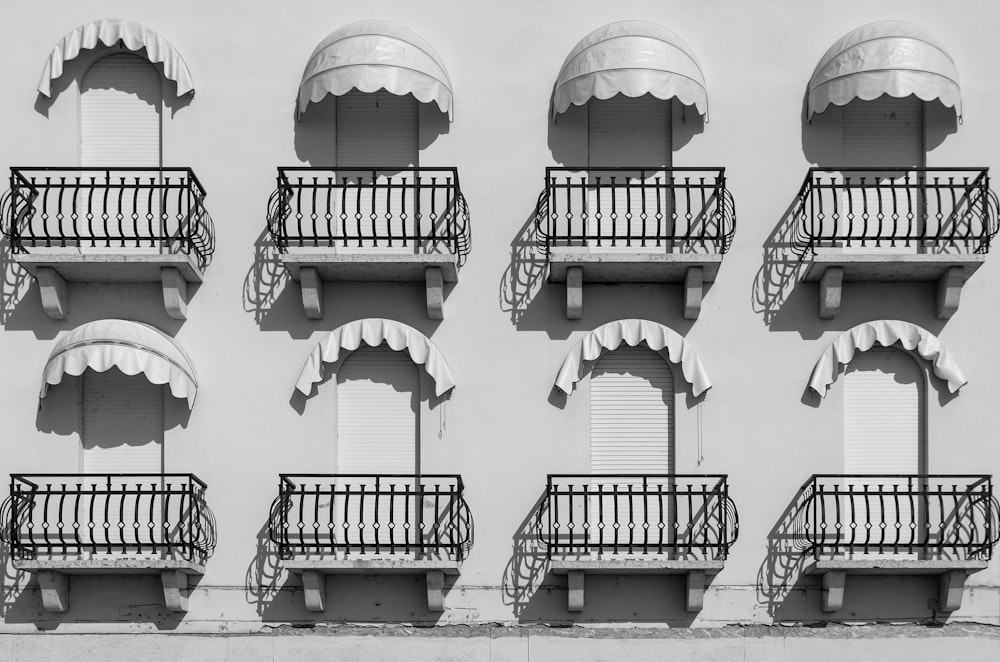 white concrete building with black metal railings