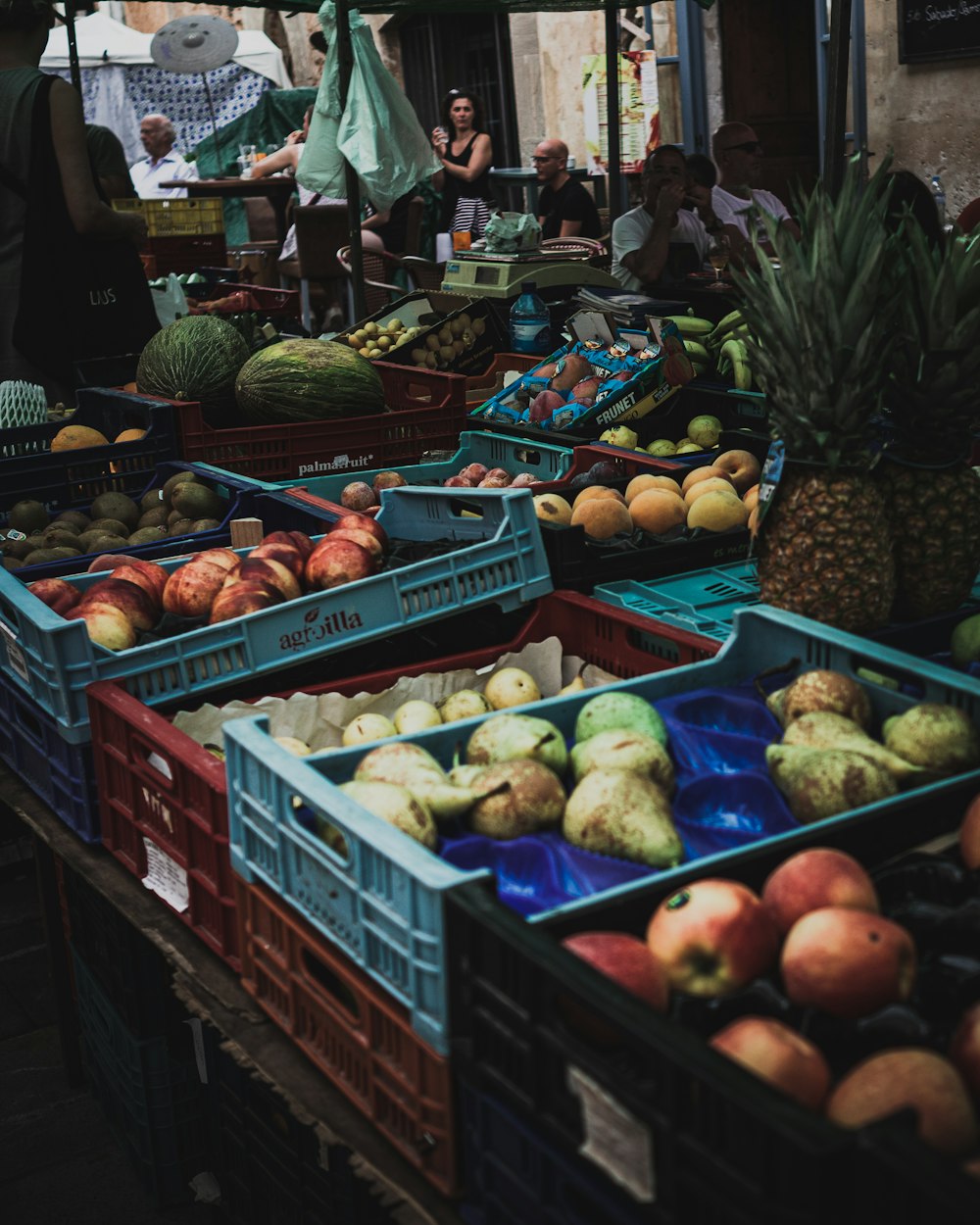 variety of fruits on blue plastic crate