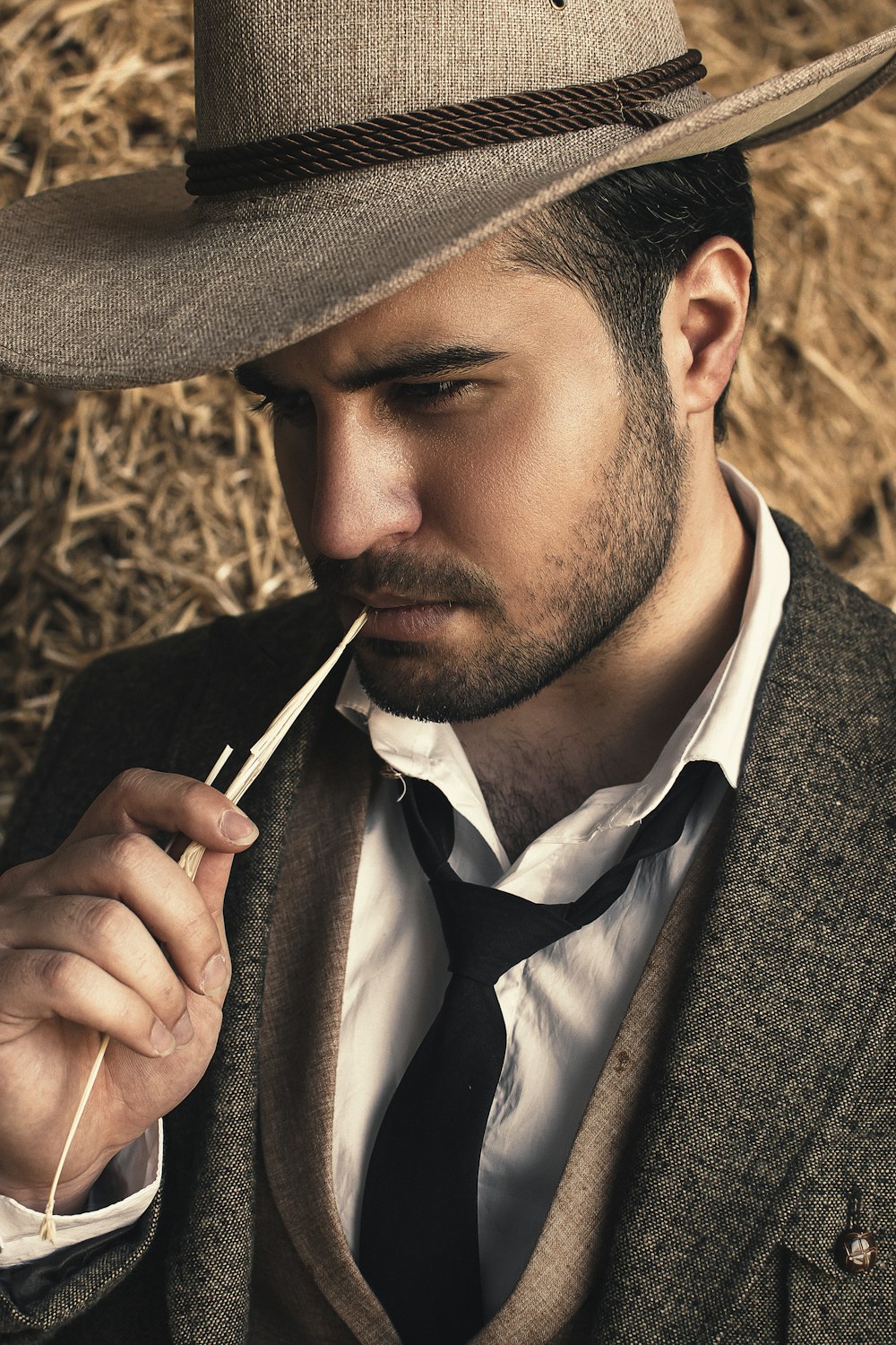 man in black hat smoking cigarette