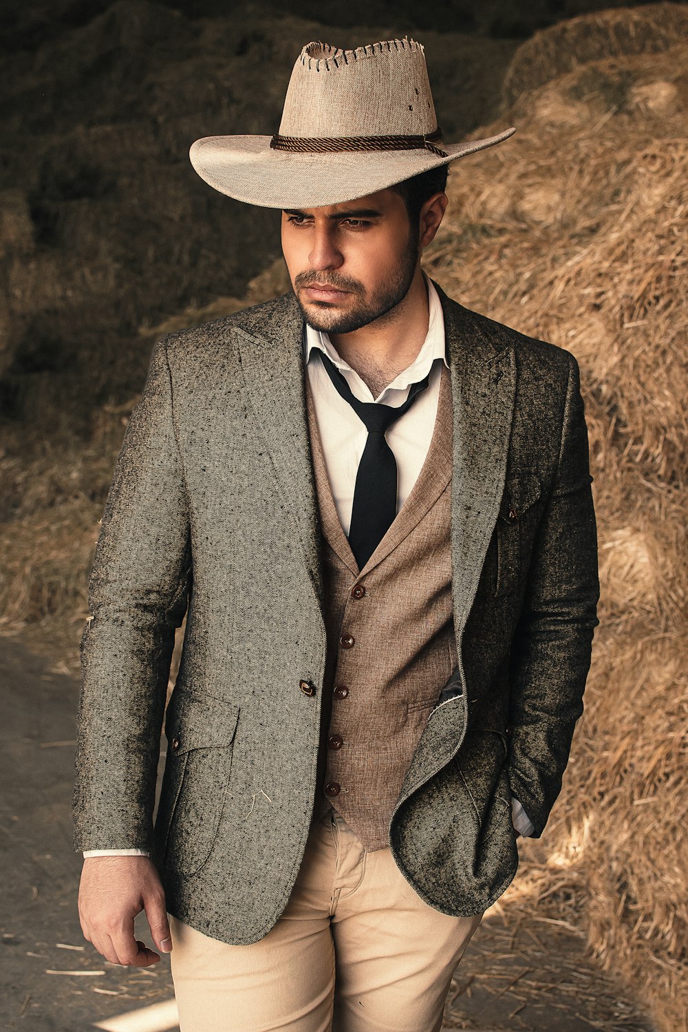 man in black suit wearing brown hat