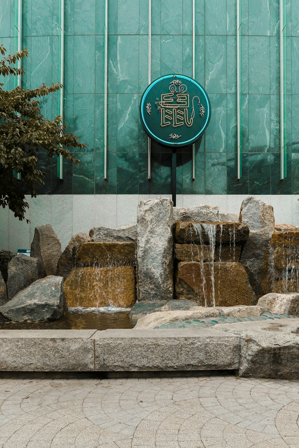 brown and gray rocks near green glass window